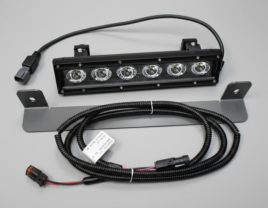 LED light bar with wiring on a dark tiled floor