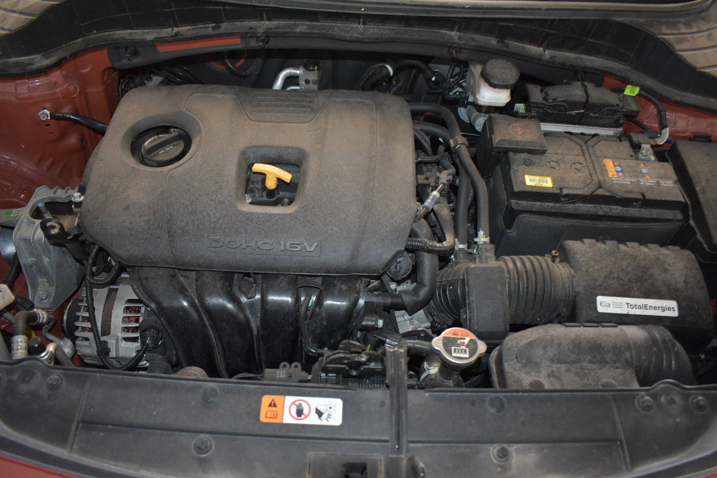 Car engine compartment with visible 'SOLAR' branding on a vehicle.