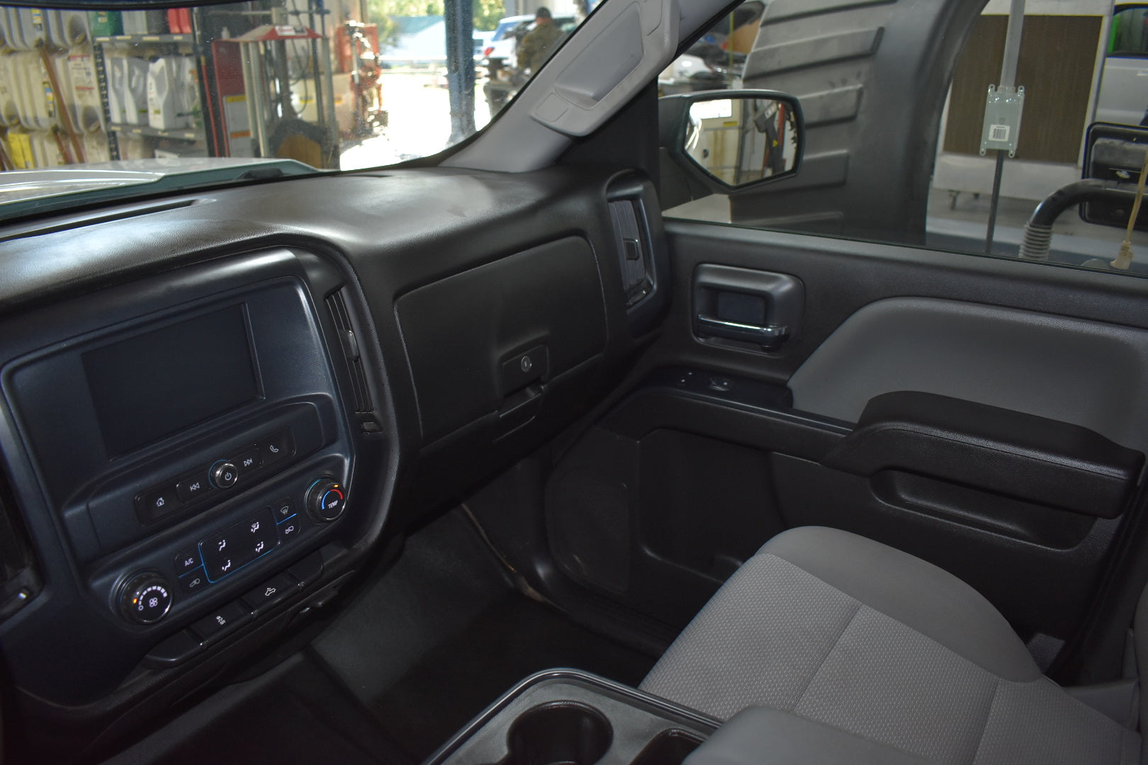 Interior of a vehicle showing dashboard, steering wheel, and door panel.