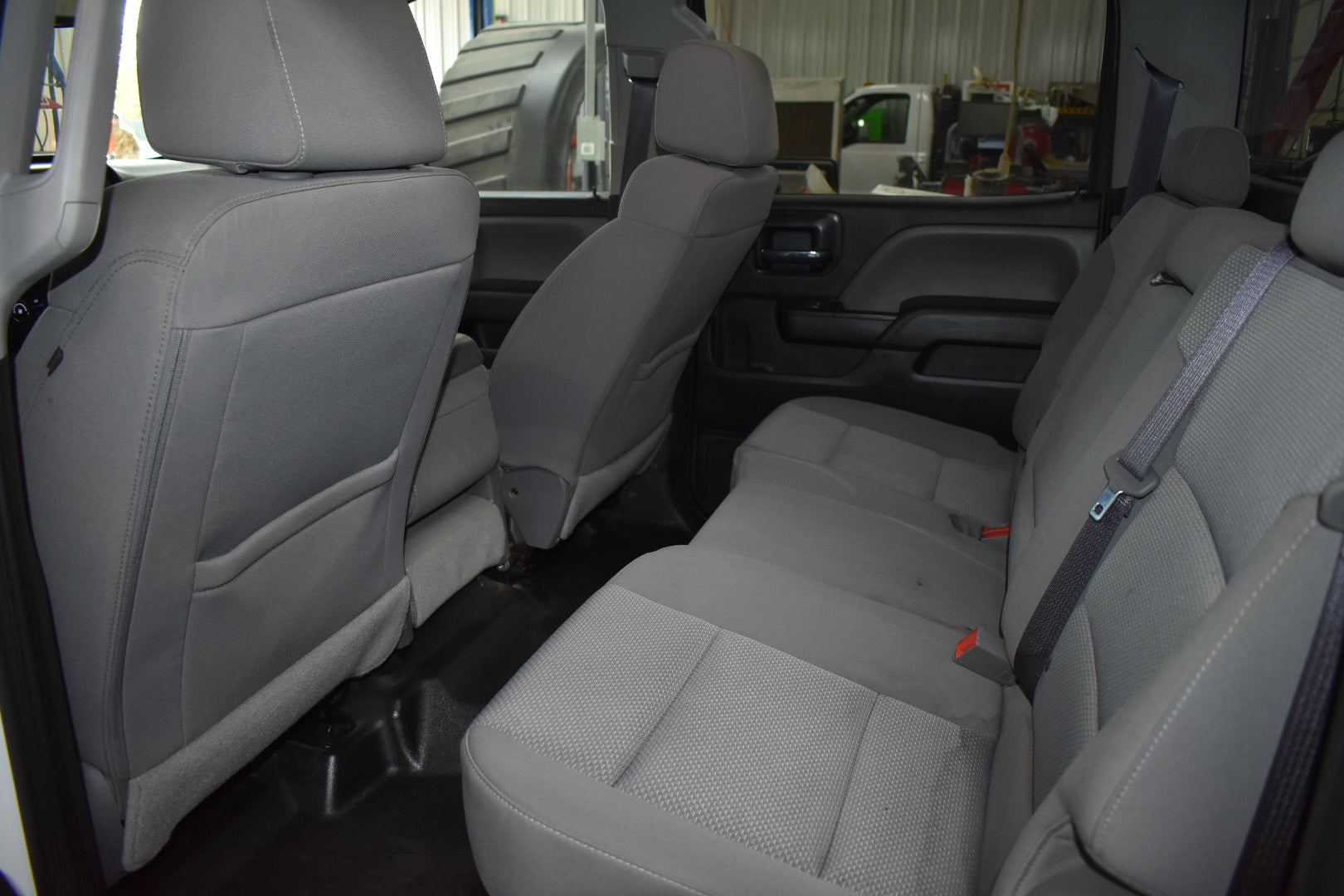 Gray interior of a vehicle with seats and door panels.