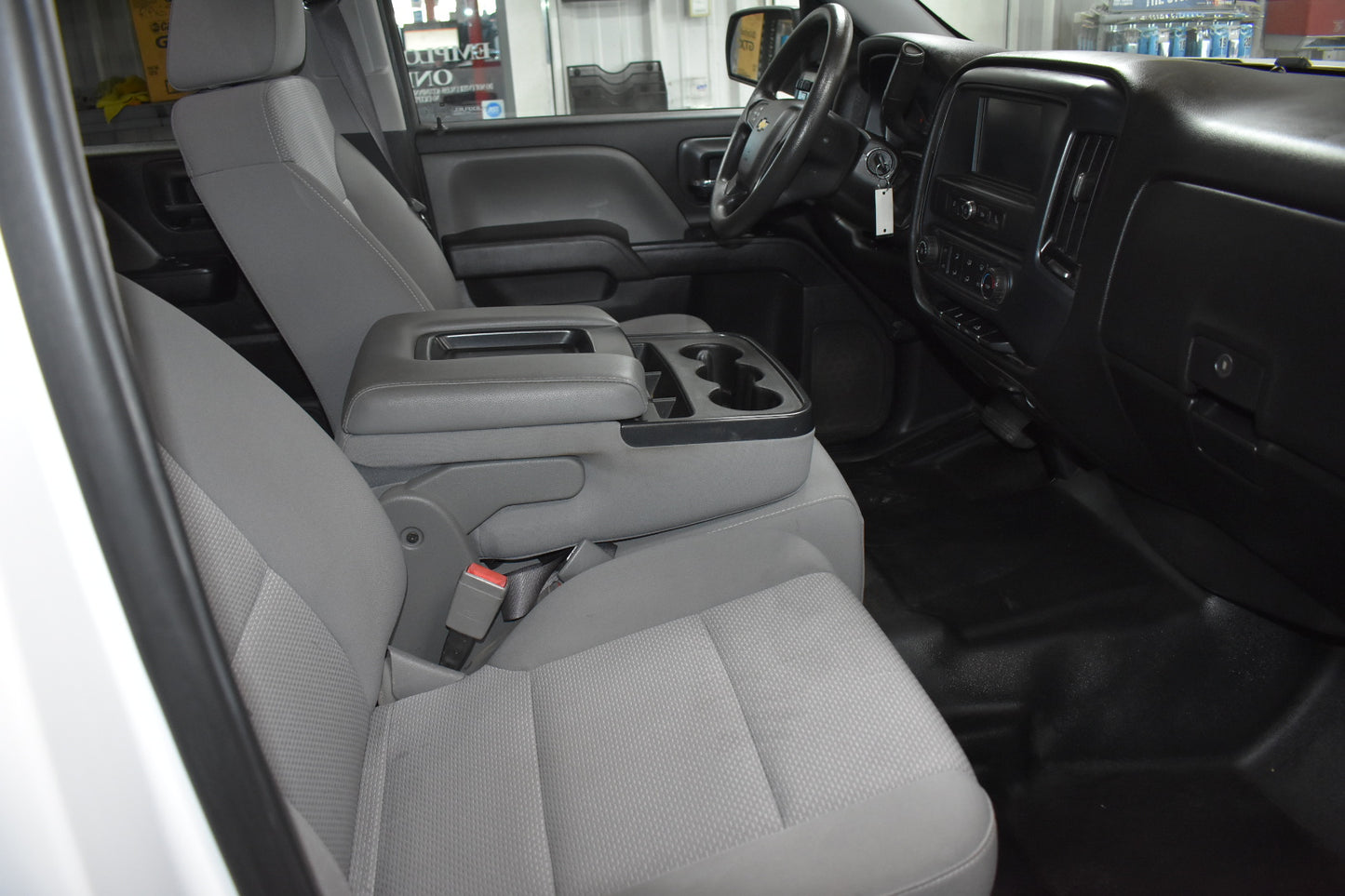 Interior of a vehicle with gray seats and dashboard.