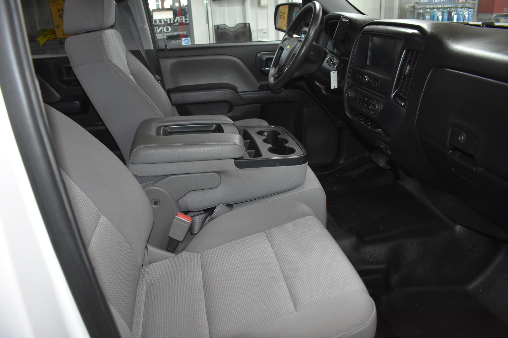 Interior of a vehicle with gray seats and dashboard.