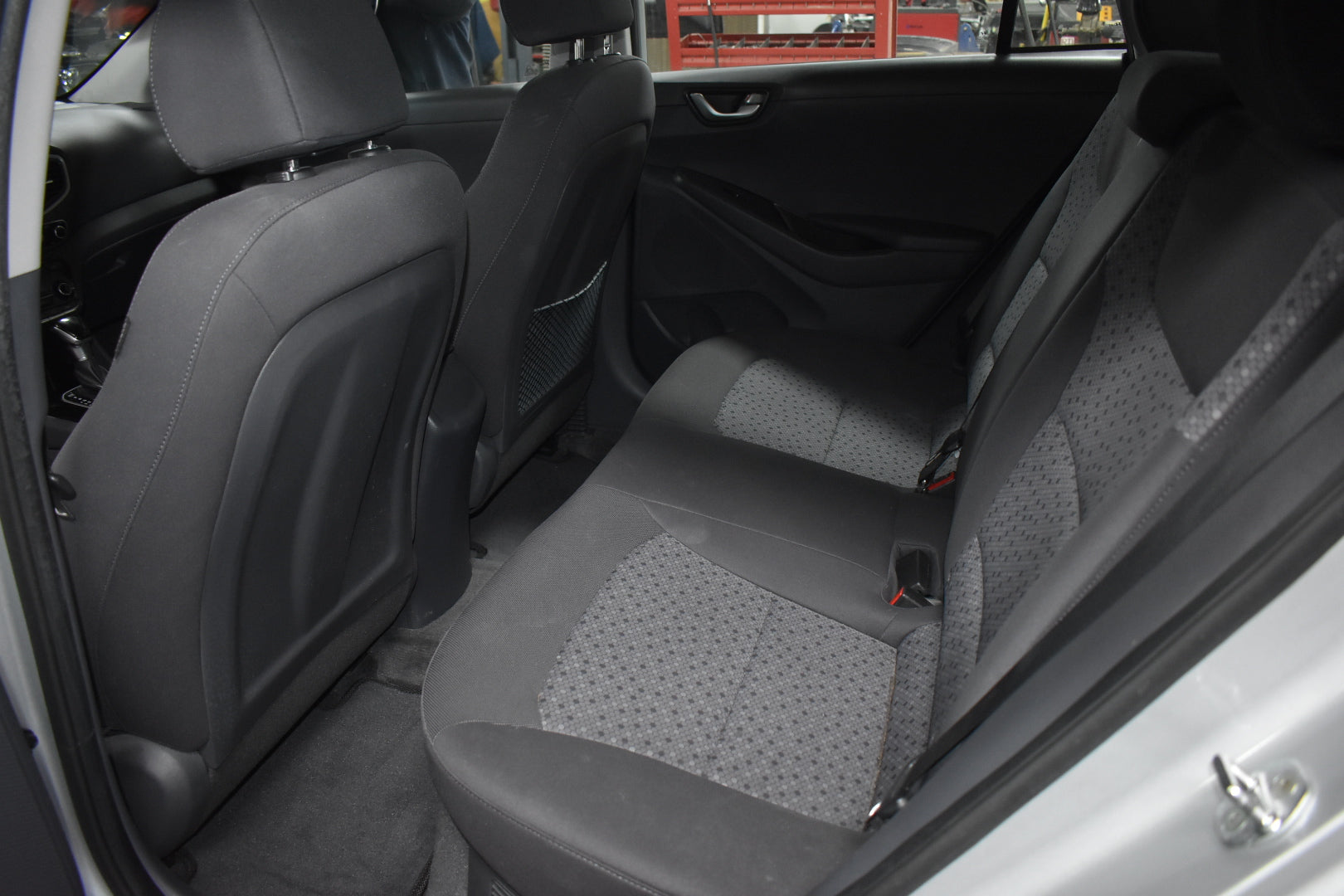 Car interior with gray seat covers on the back seat