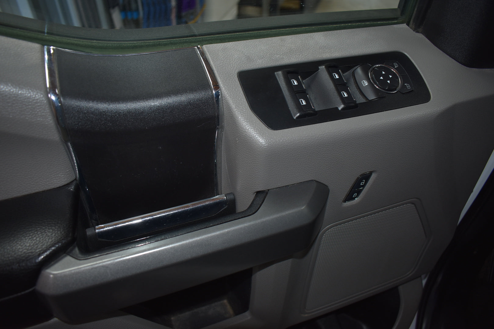 Car door panel with window control switches and handle