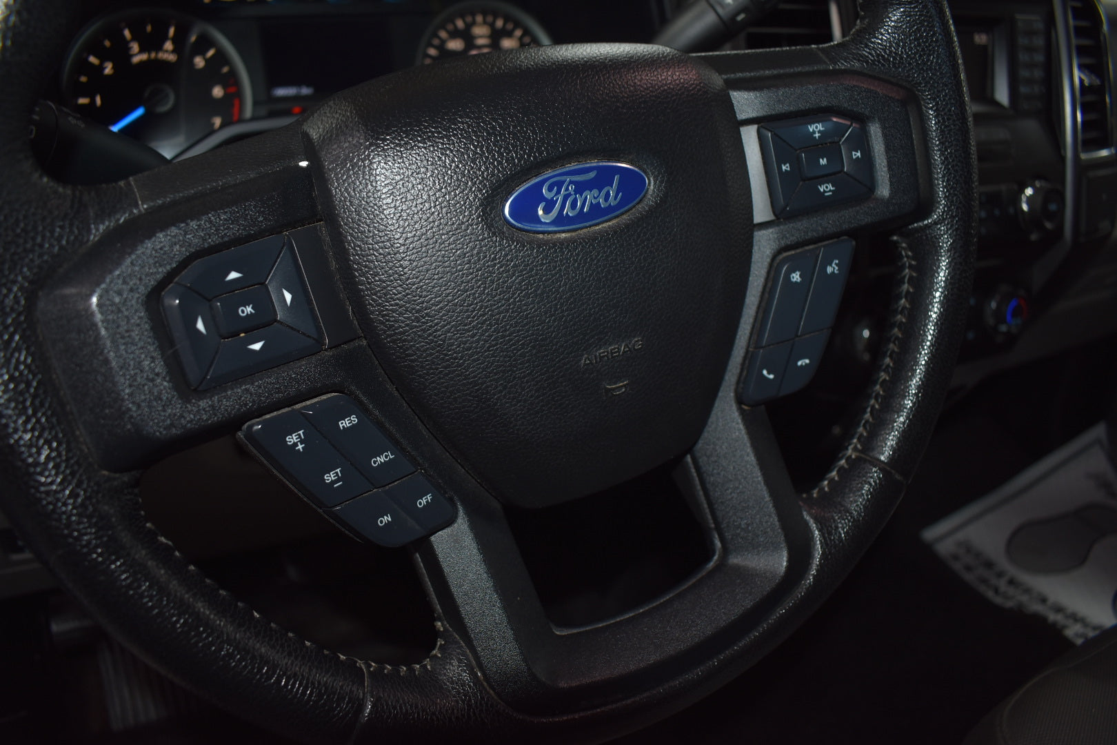 Steering wheel with Ford logo in a vehicle interior