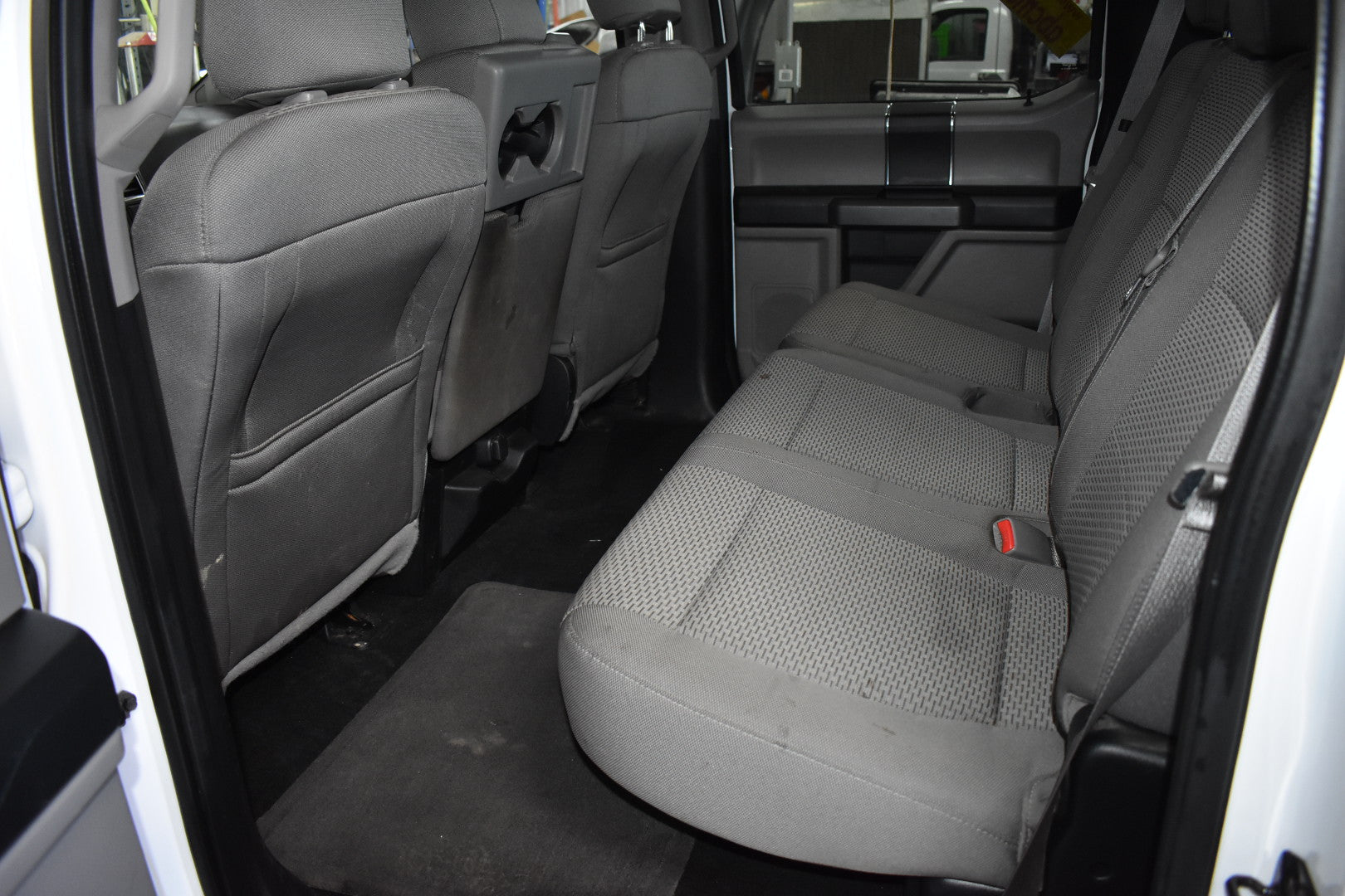 Interior of a vehicle showing gray seats and door panels.
