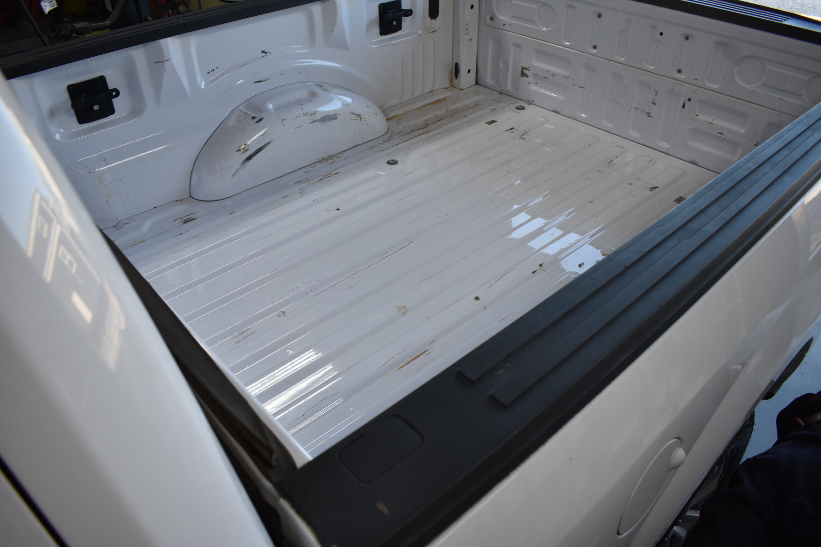 Clean and empty truck bed with a white liner