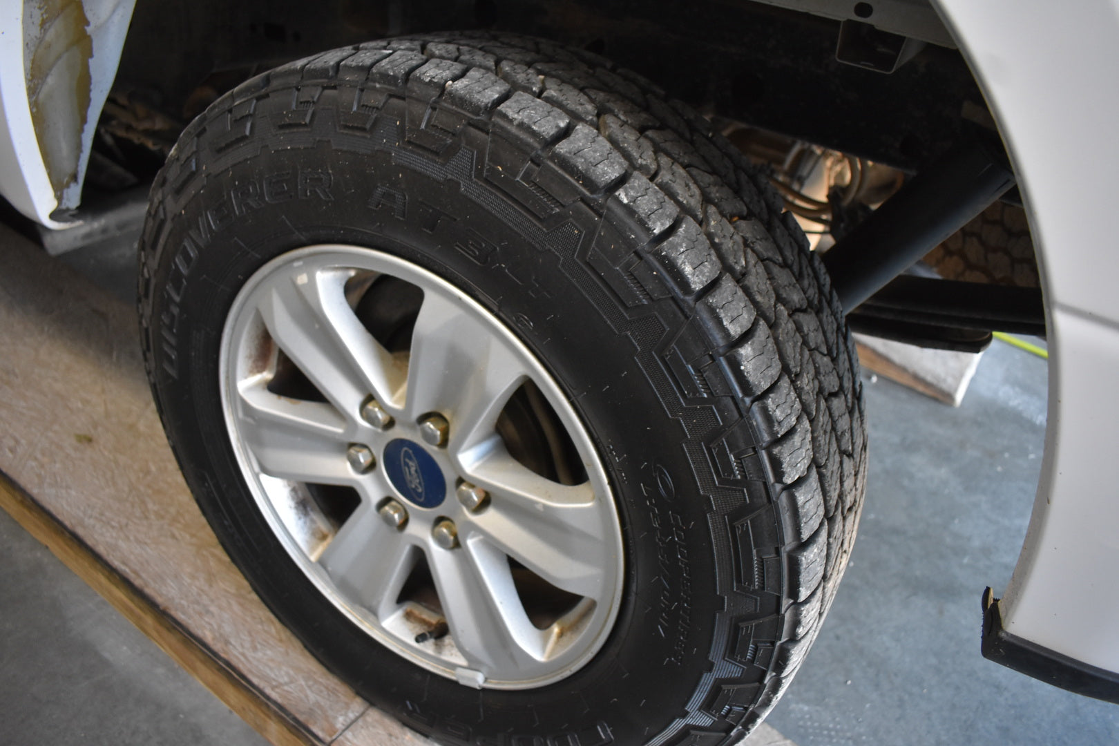 Close-up of a tire with a visible Ford logo on a vehicle.