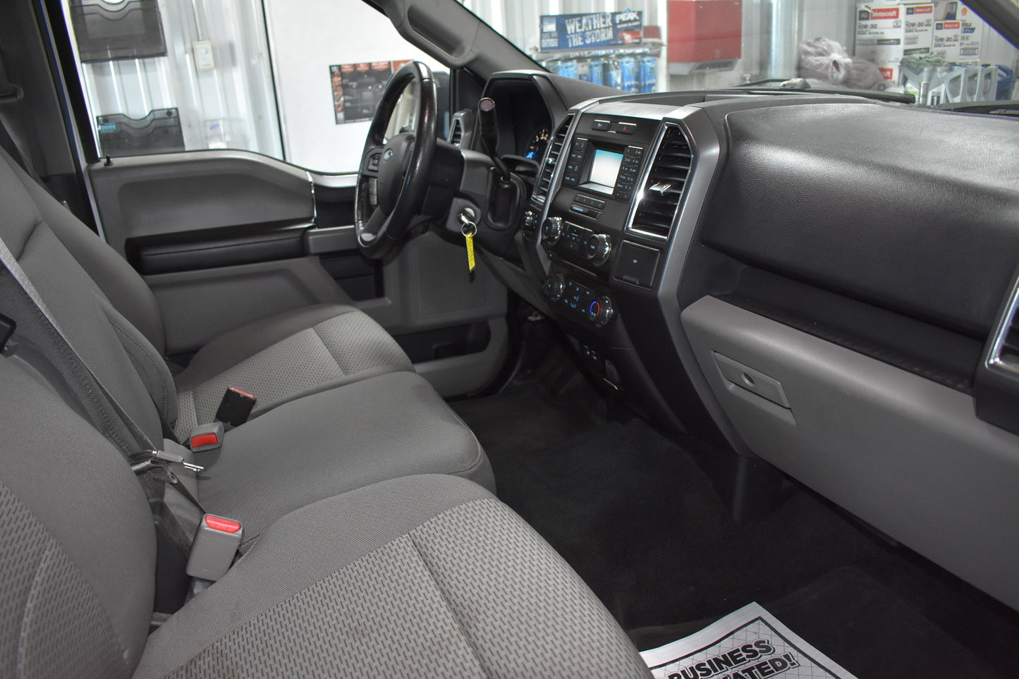 Car interior with gray seats and dashboard in a showroom setting