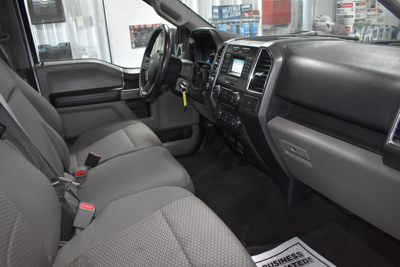 Car interior with gray seats and dashboard in a showroom setting