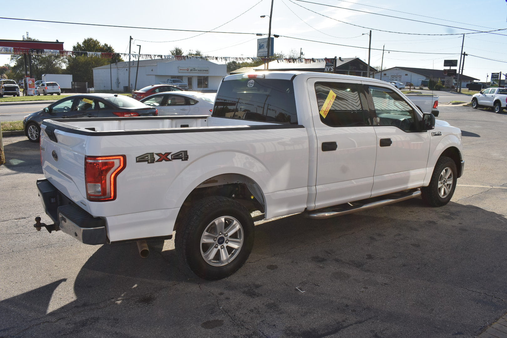 White pickup truck with '4x4' label on a street