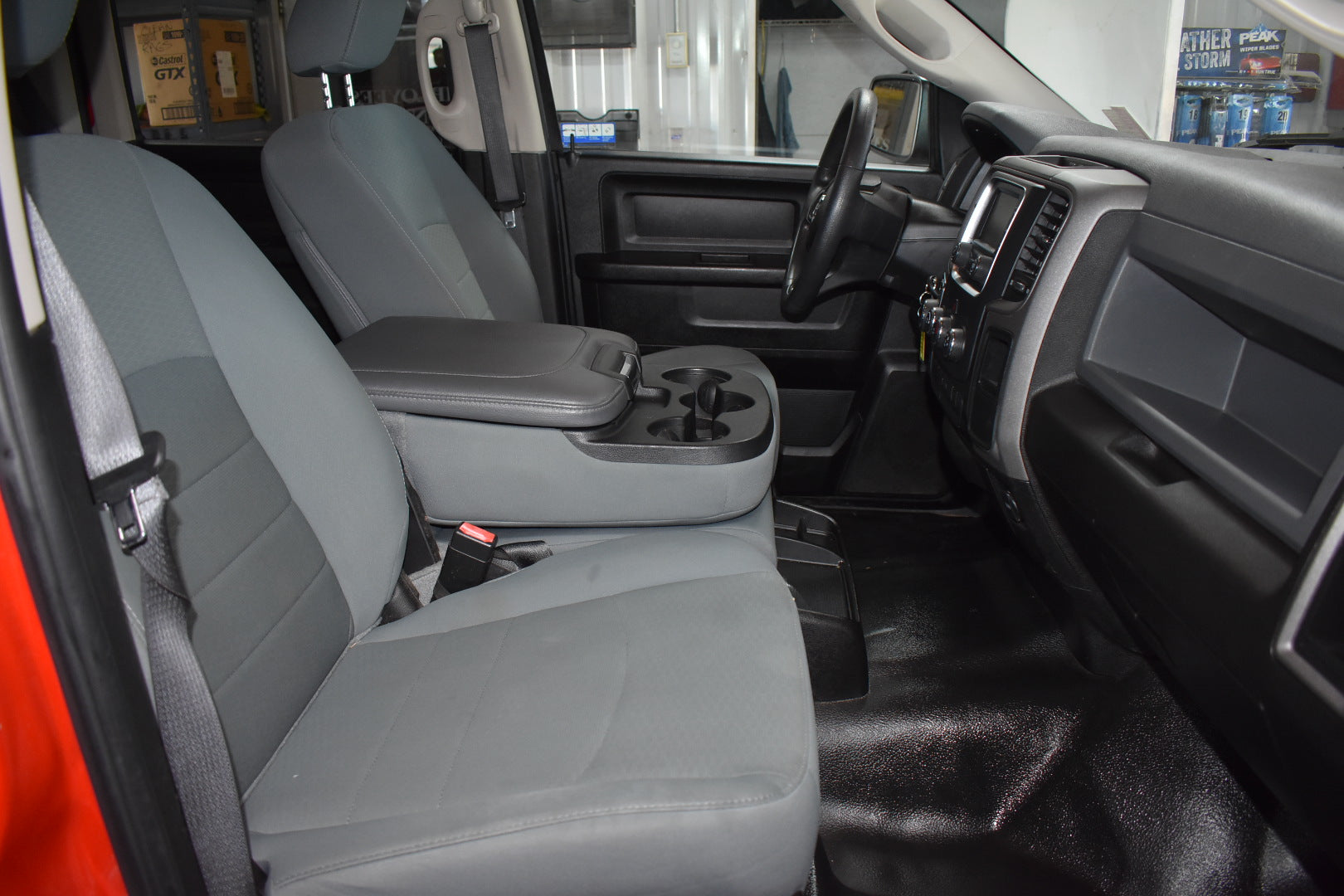 Interior of a vehicle with gray seats and dashboard.
