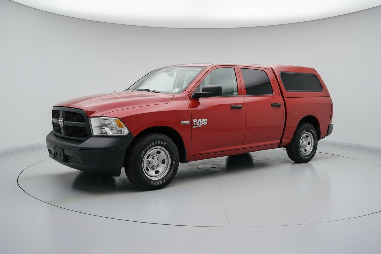 Red pickup truck parked in front of a building with a wreath on the door.