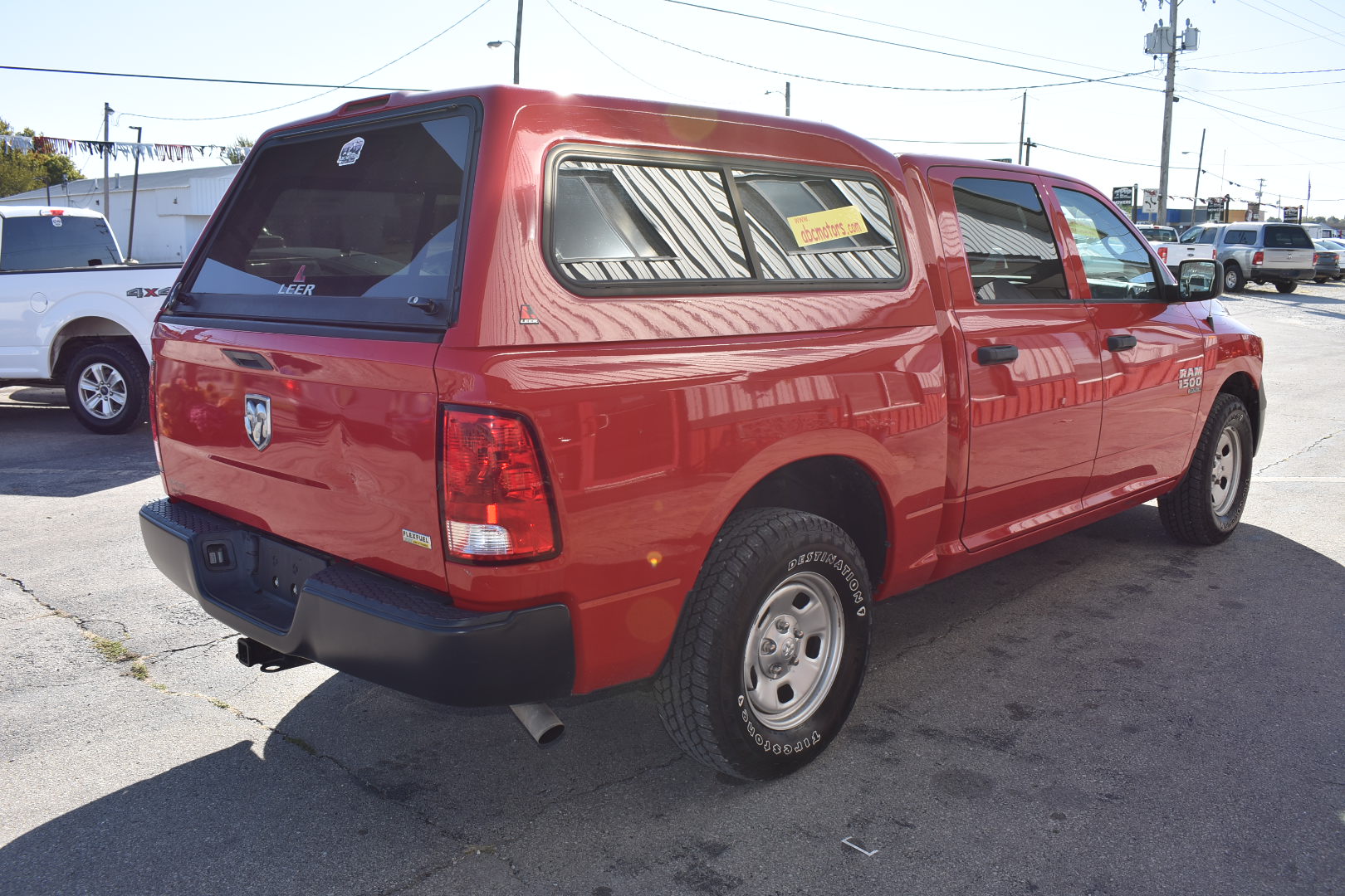 Red pickup truck with a canopy in an outdoor setting