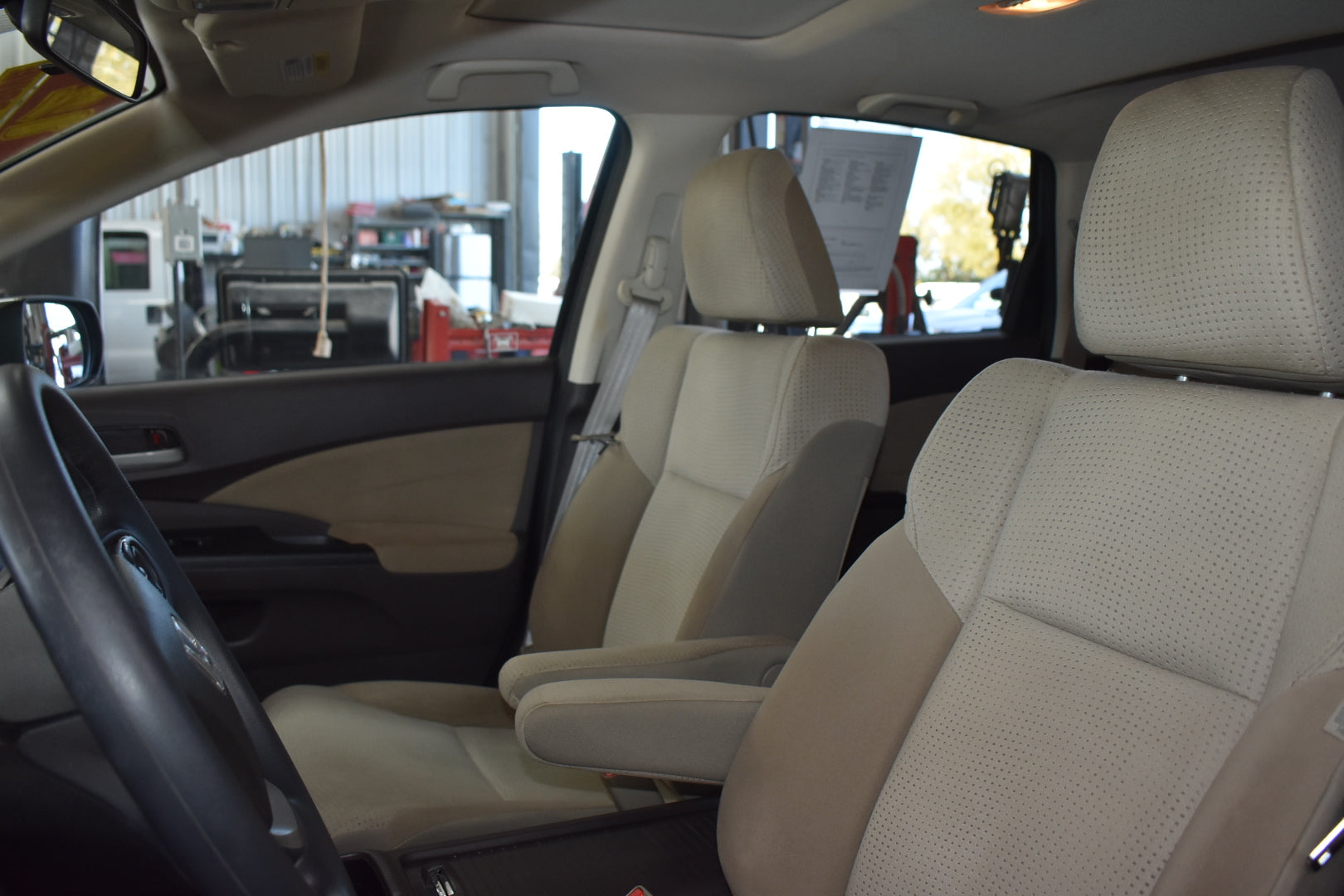 Car interior with beige seats in a showroom setting