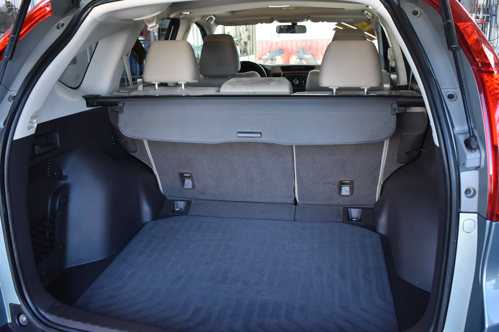 Open car trunk with folded rear seats in a clear background