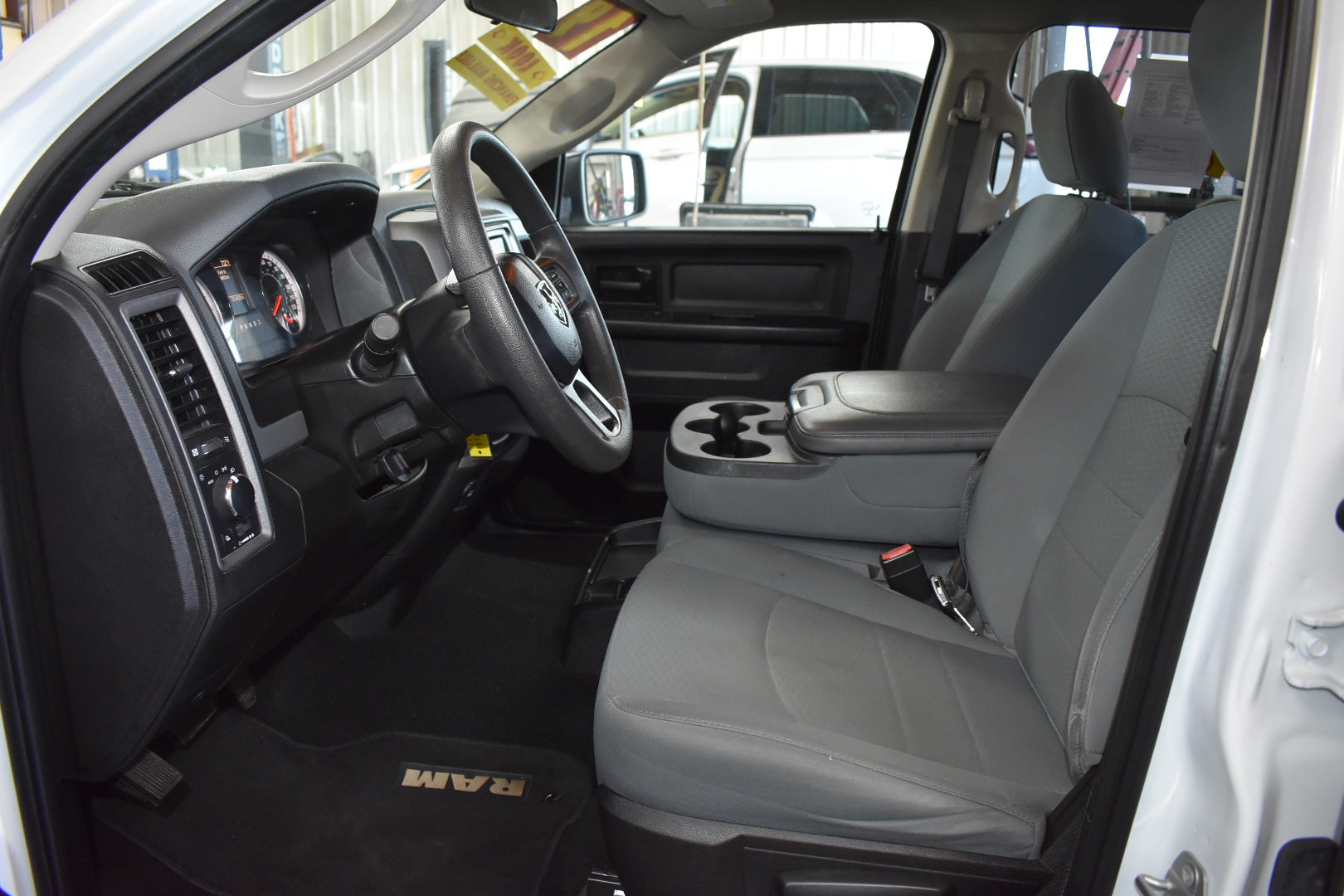 Interior of a RAM truck with gray seats and dashboard.
