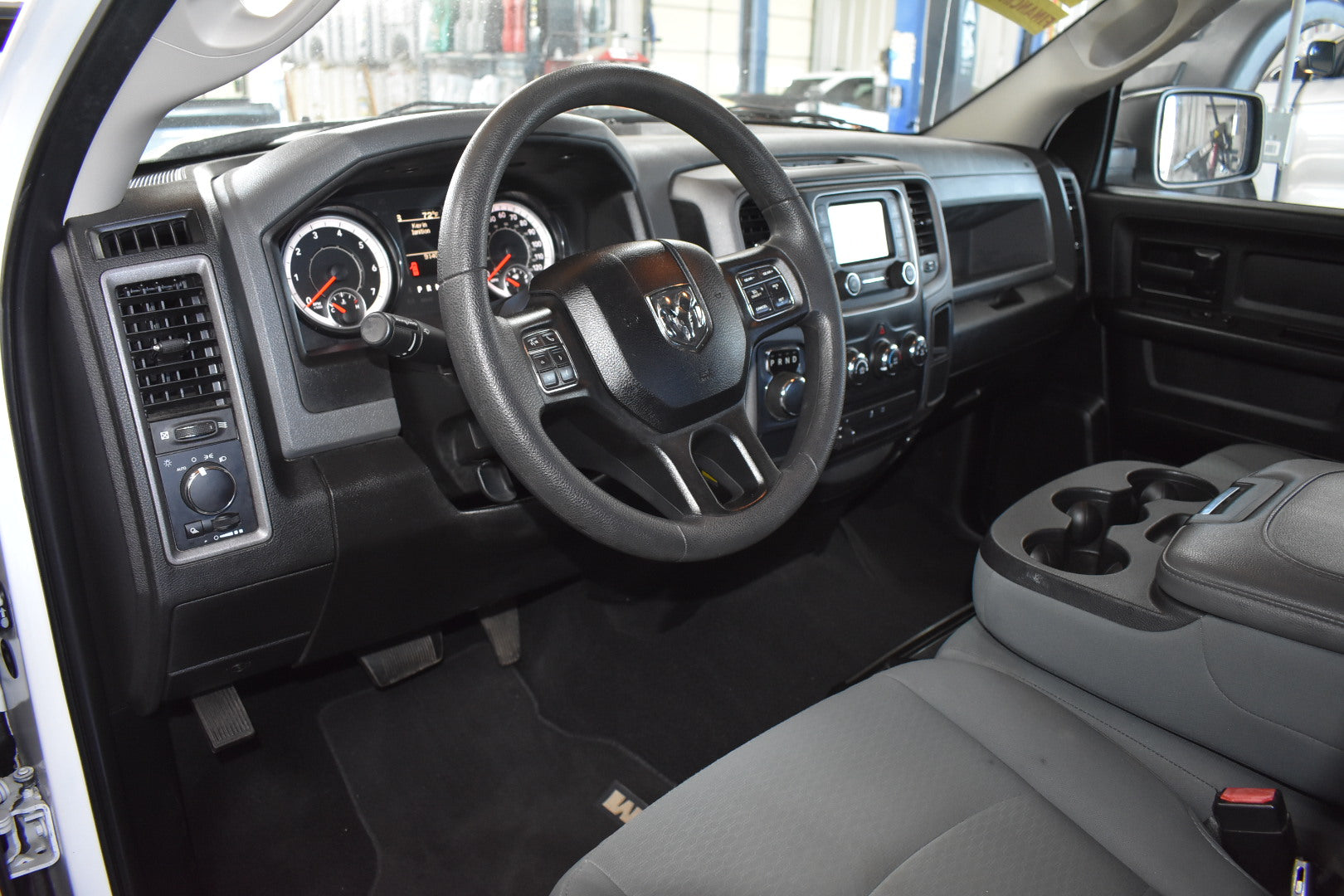 Interior of a vehicle showing steering wheel and dashboard