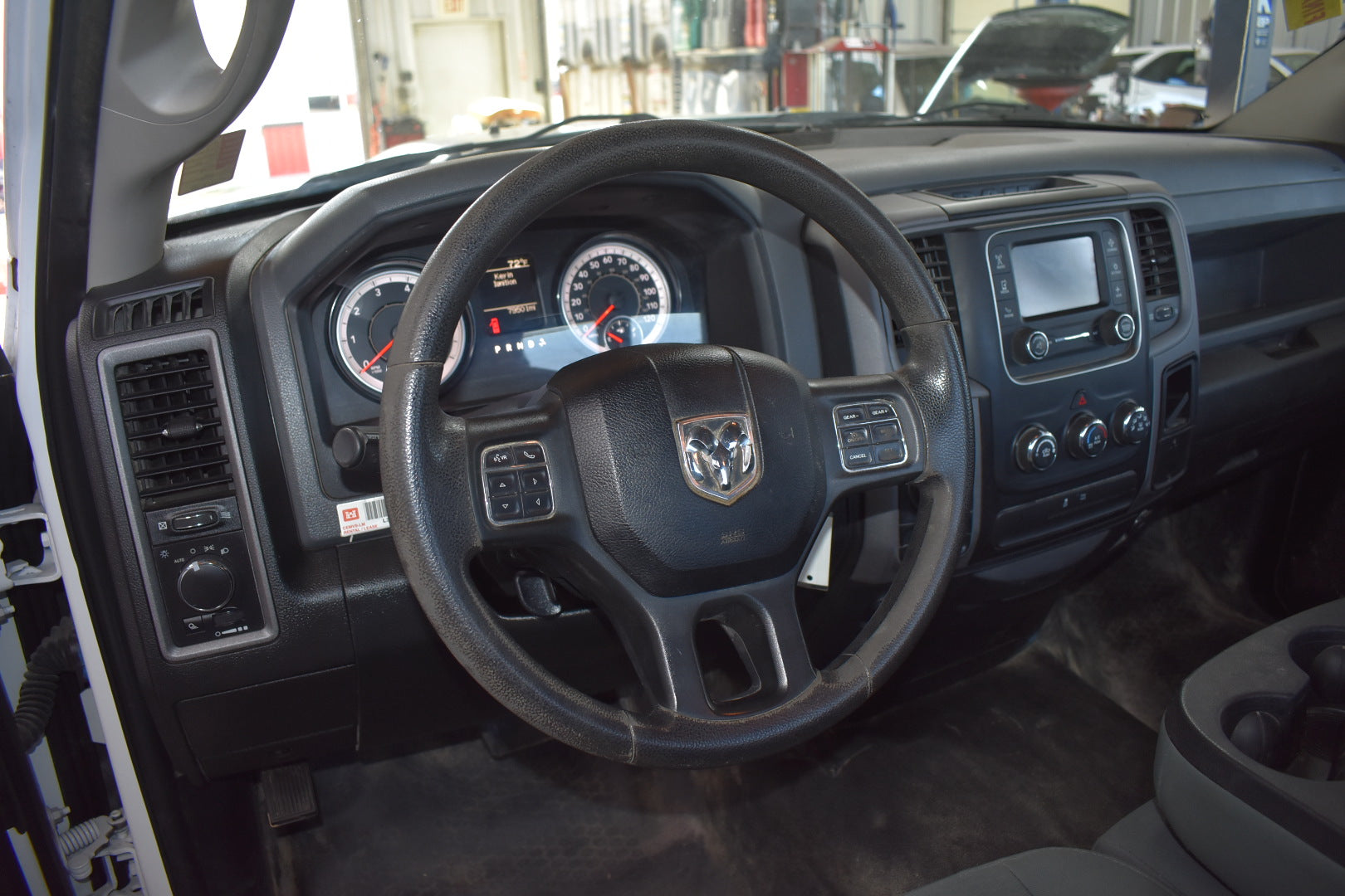 Car interior with steering wheel and dashboard in a showroom setting