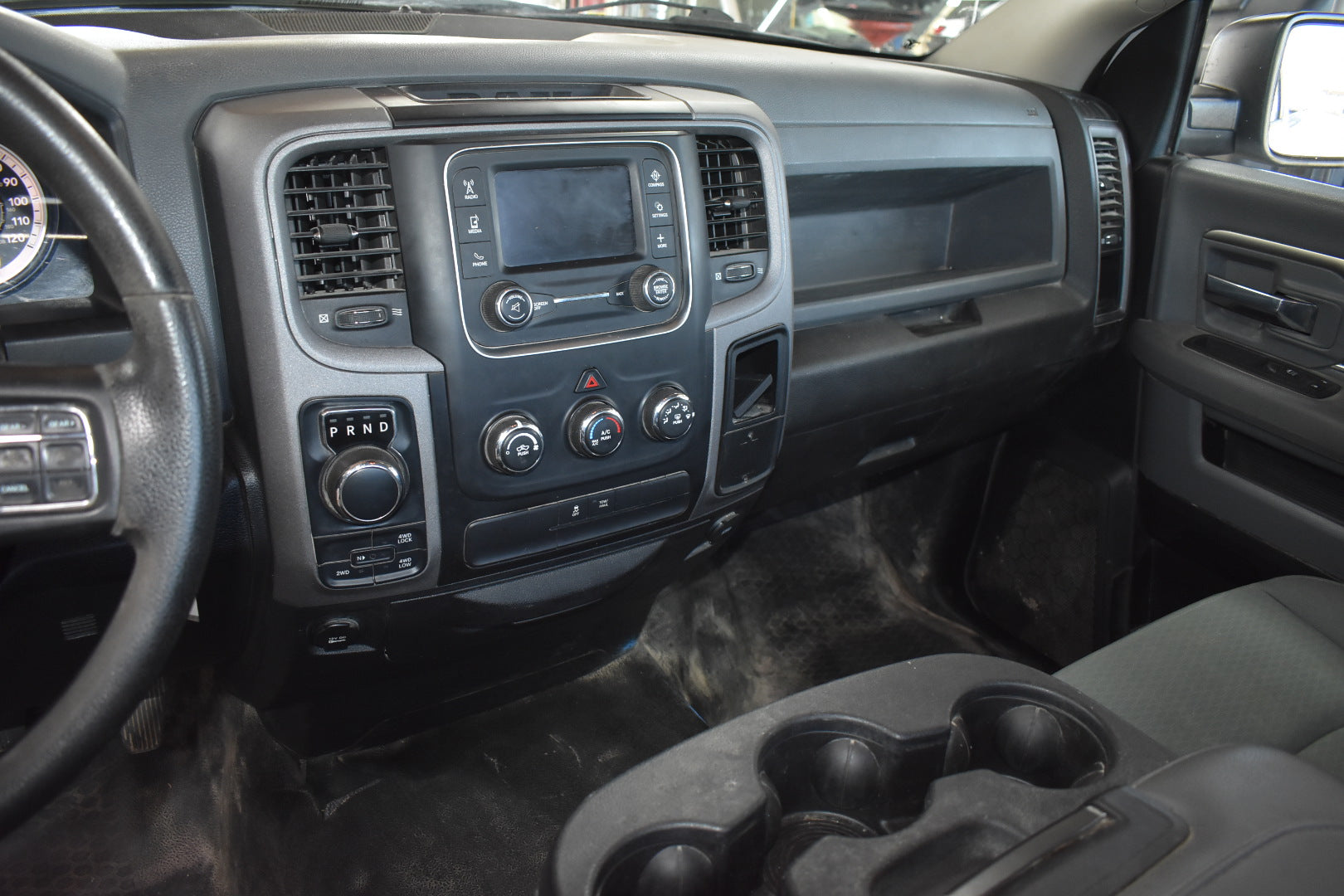 Close-up of a car's dashboard and steering wheel interior.