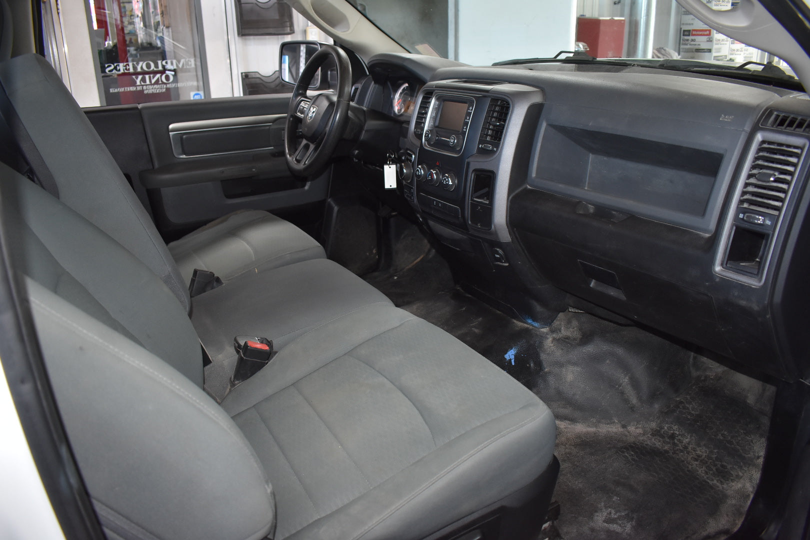 Car interior with gray seats and dashboard in a showroom setting