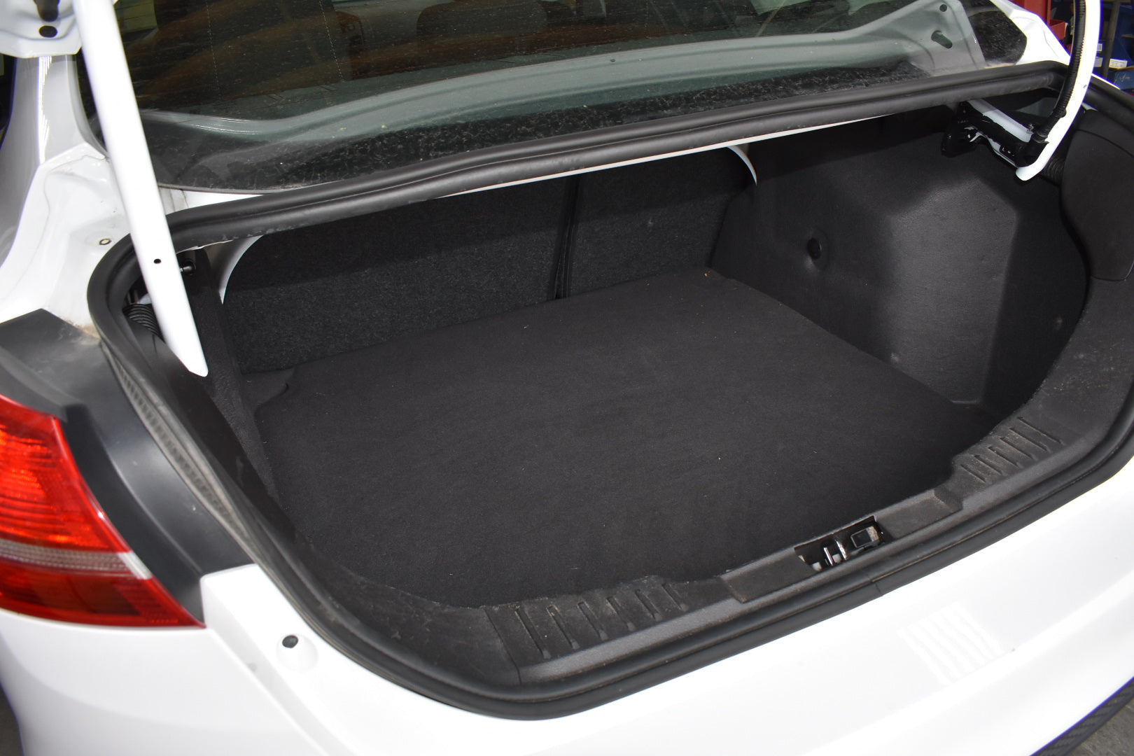 Open car trunk with a black cargo liner