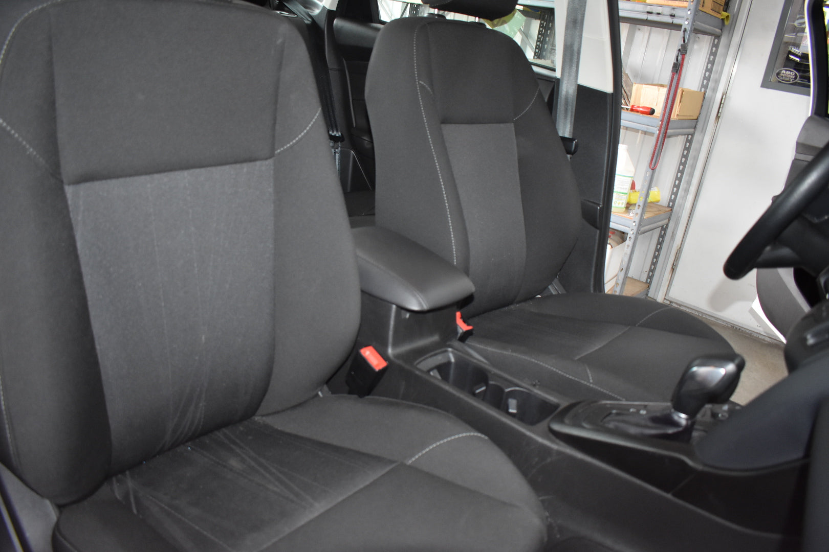 Gray car seats inside a vehicle with a blurred background