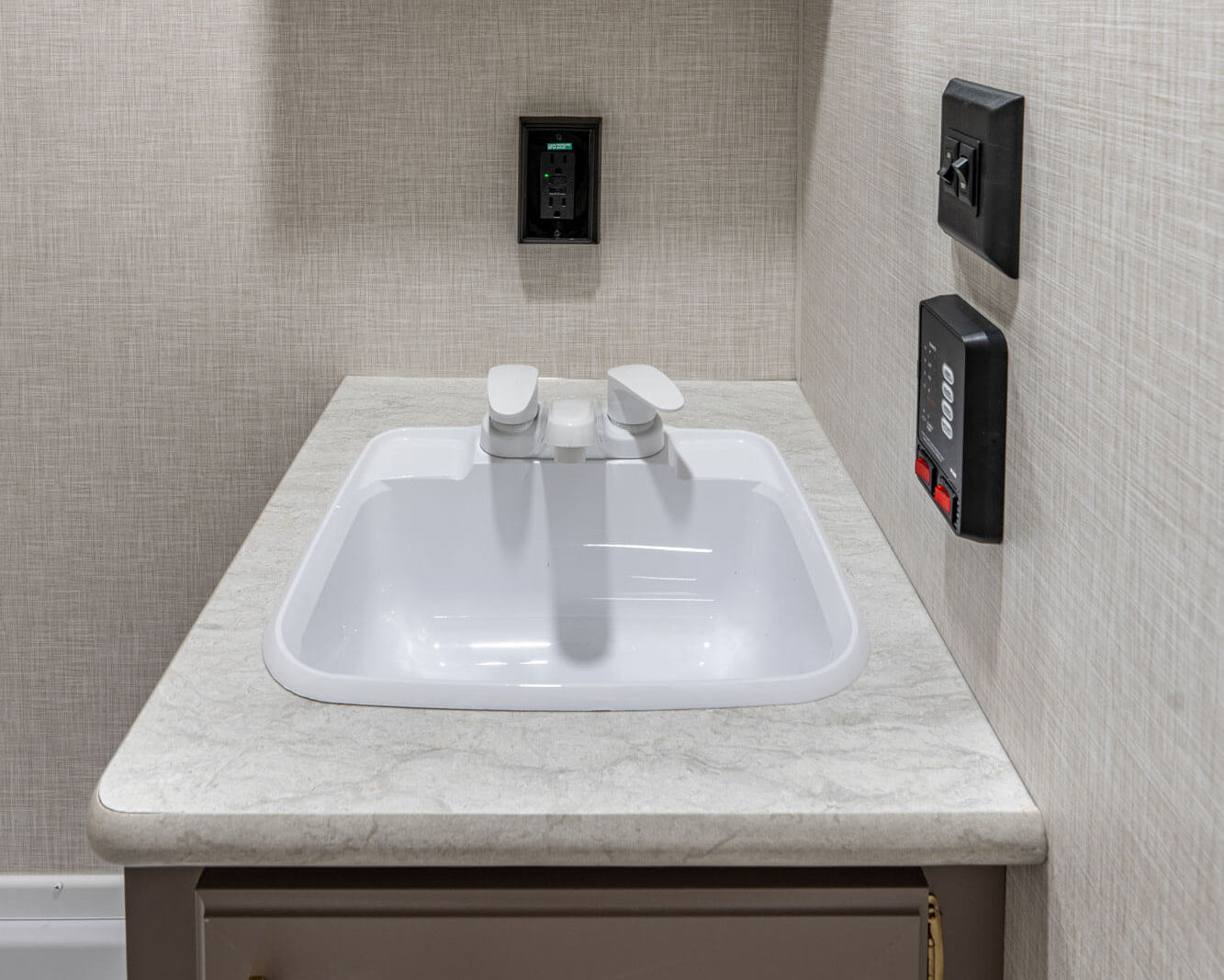 Bathroom sink with mirror and cabinets in a compact space