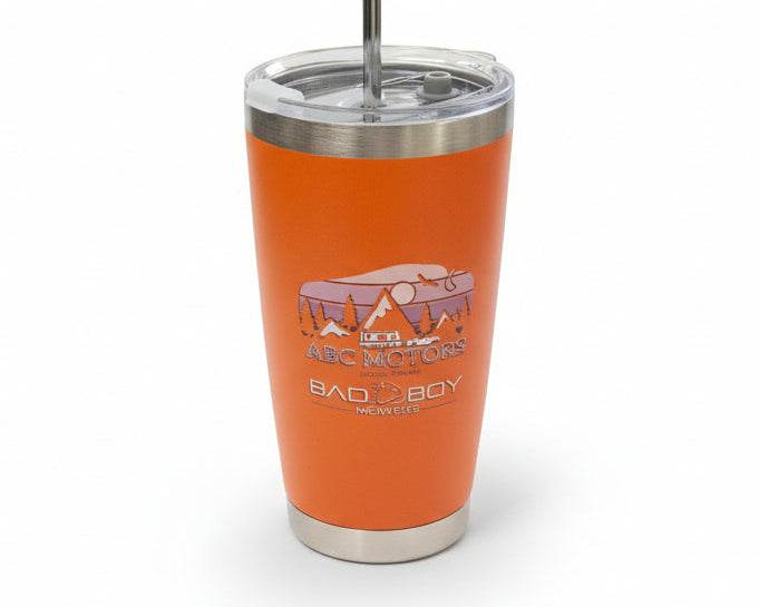 Orange tumbler with a logo on a concrete surface