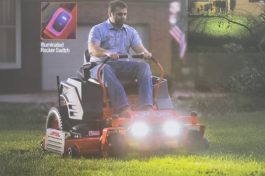 Person using a lawn mower with a close-up of a switch labeled 'Illuminated Rocker Switch'.
