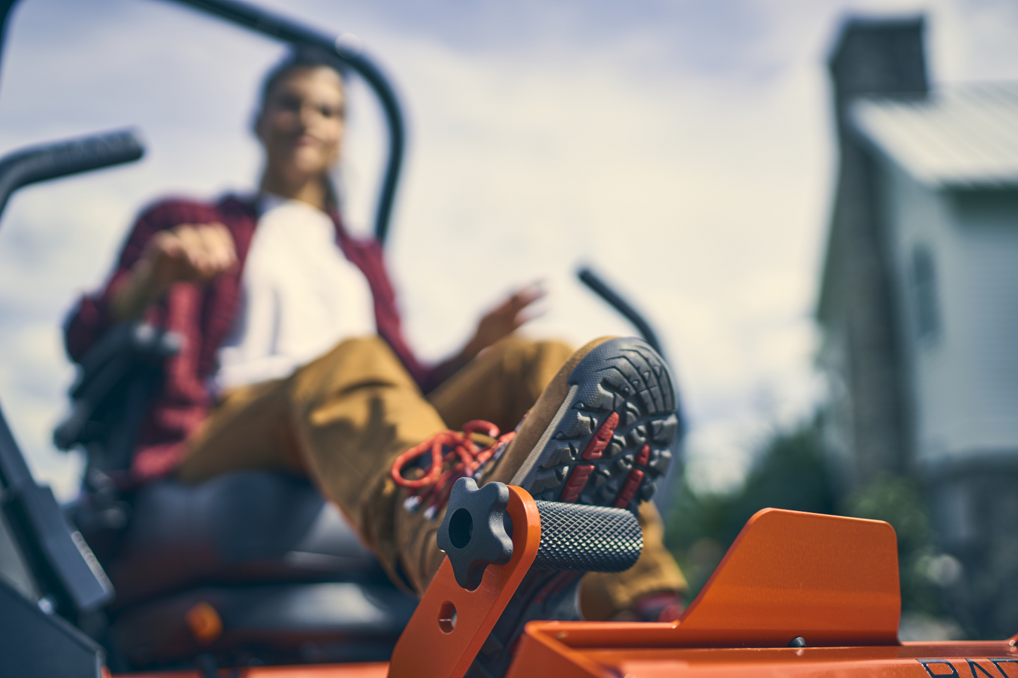Person sitting on a piece of machinery with a blurred background