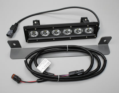 LED light bar with wiring on a dark tiled floor