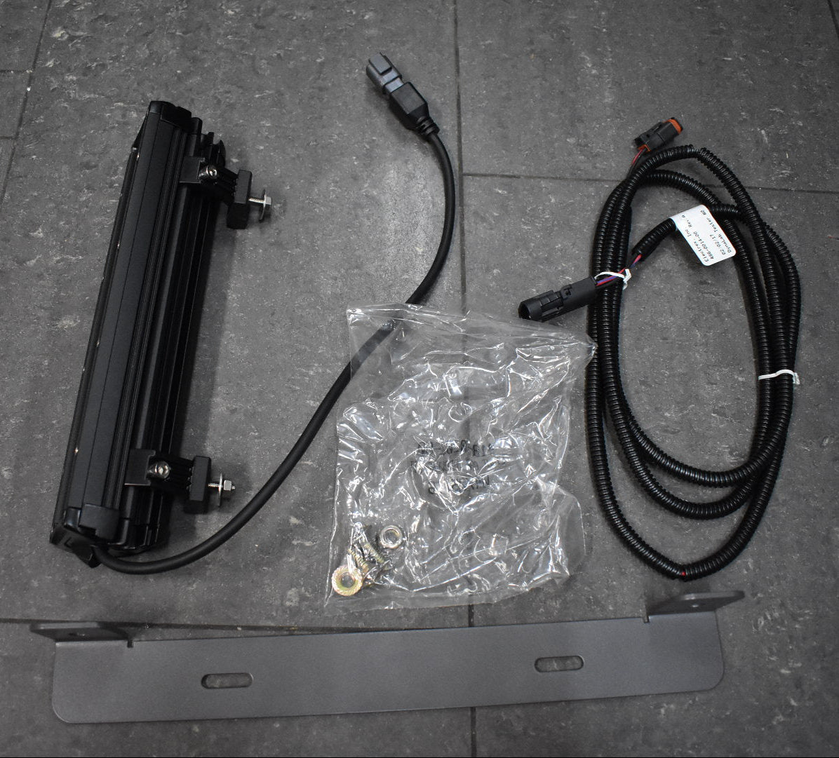 Electrical components including a flat panel, cables, and connectors on a tiled floor.