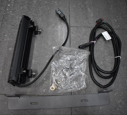 Electrical components including a flat panel, cables, and connectors on a tiled floor.