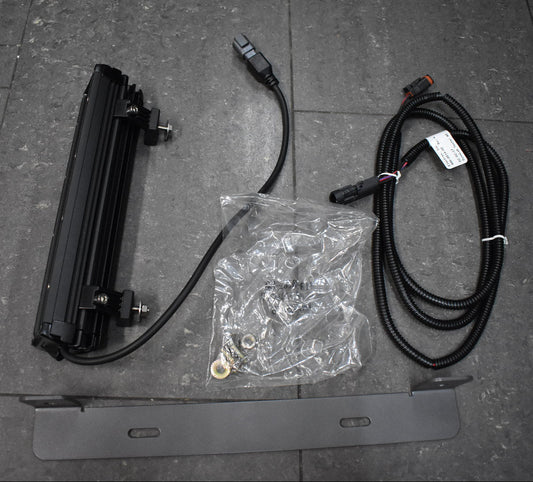 Electrical components including a flat panel, cables, and connectors on a tiled floor.