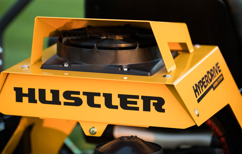 Yellow Hustler Hyperdrive machine part with branding on a blurred background