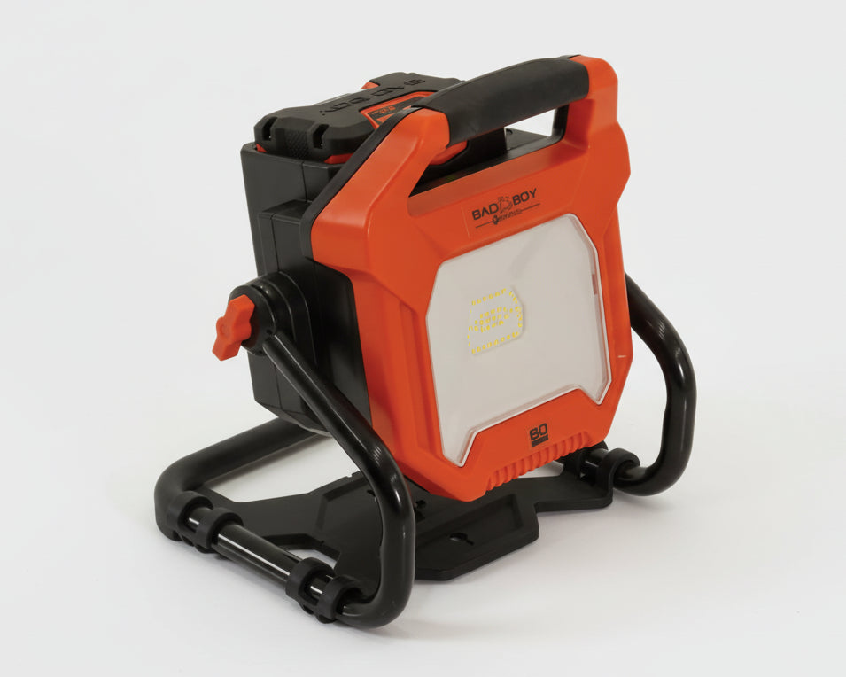 Orange and black portable work light with 'Bad Boy' branding on a white background