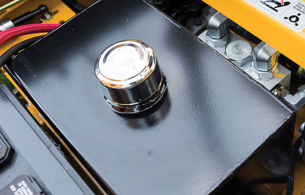 Metallic knob on a mechanical device with visible wiring and components.