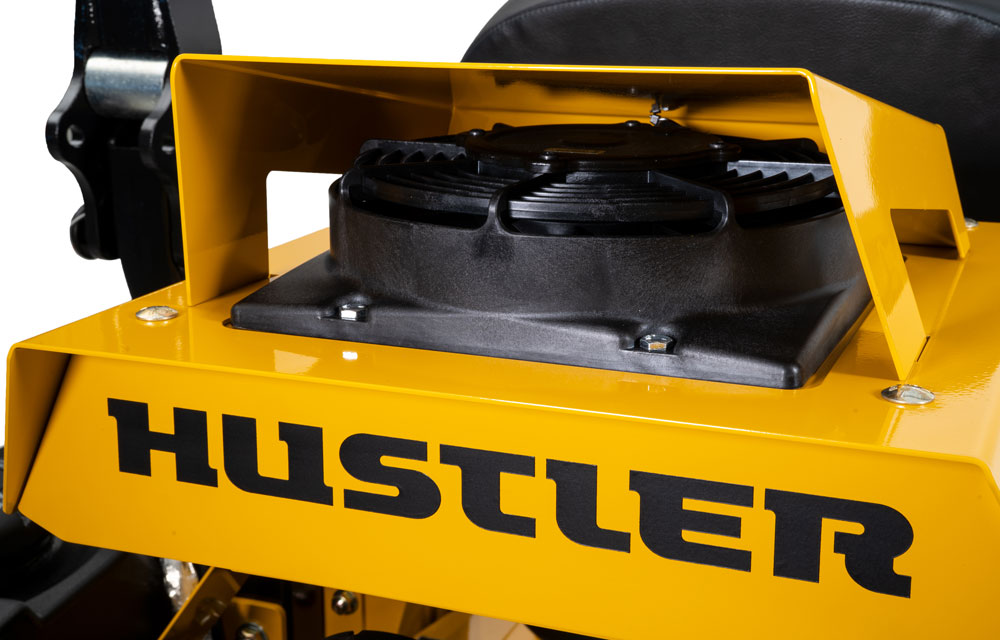 Close-up of a yellow Hustler lawn mower deck with black branding.