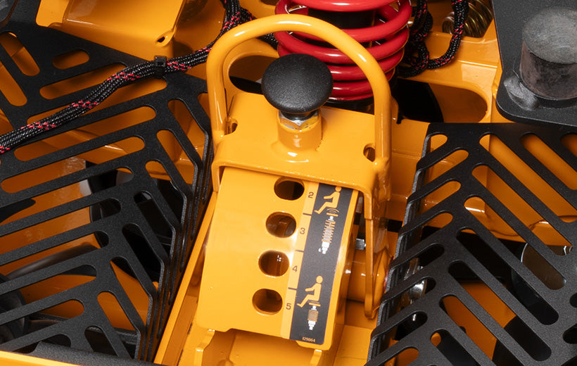 Close-up of a yellow mechanical component with black and red parts