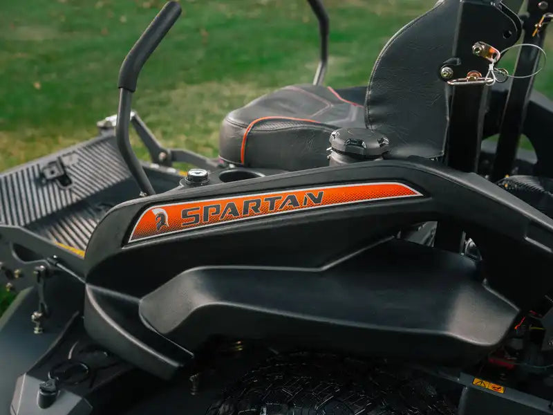 Close-up of a lawn mower with 'Spartan' branding on the deck.