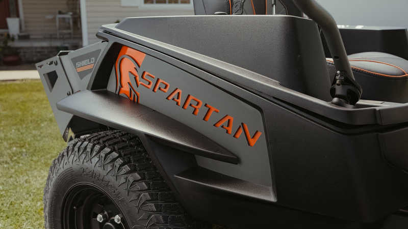 Spartan utility vehicle with visible branding on a grassy area.