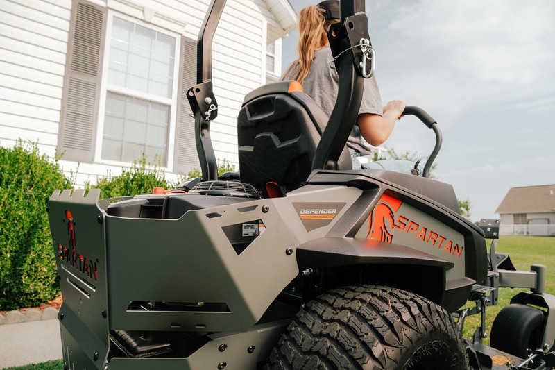 Spartan lawn mower with a person operating it in a residential setting