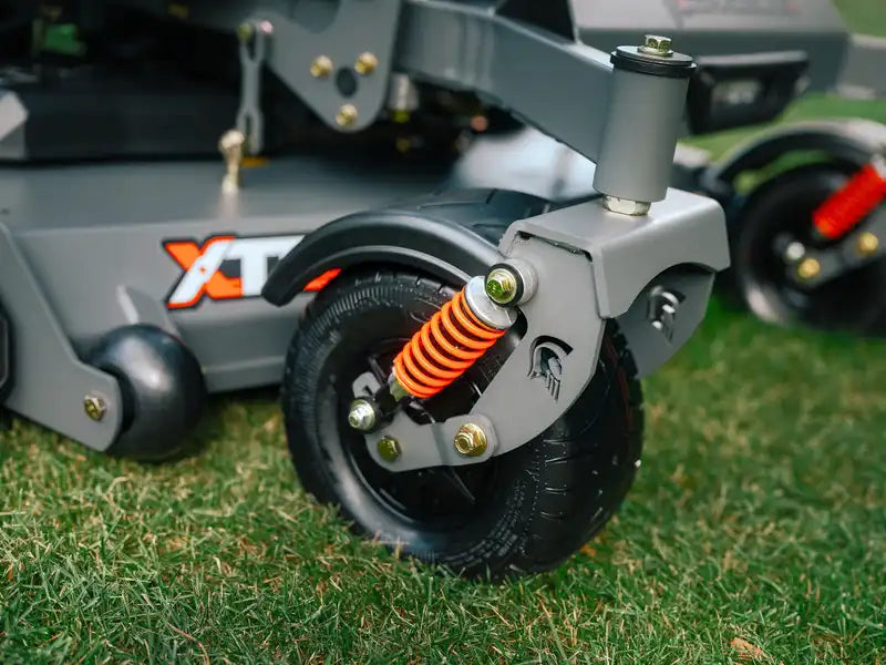 Close-up of a lawn mower with a visible brand logo on the grass.