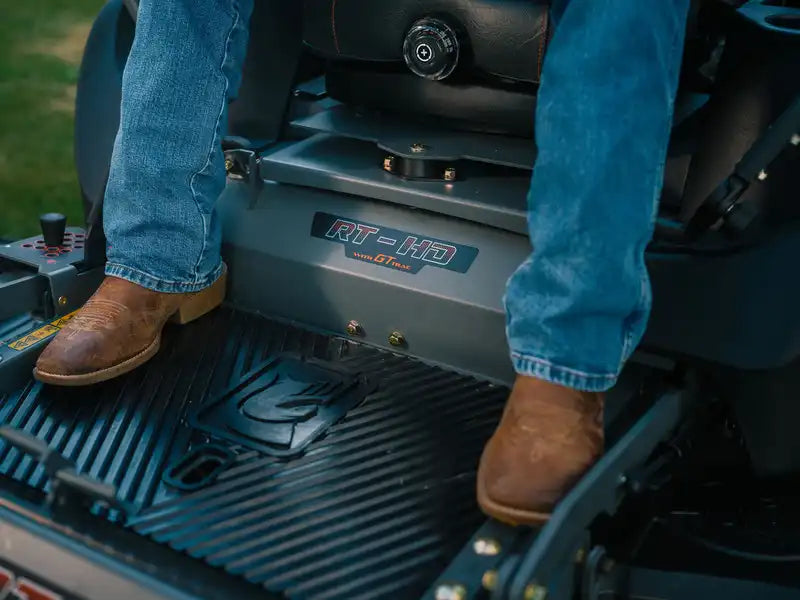 Person sitting inside a piece of heavy machinery with 'RT HD' branding.