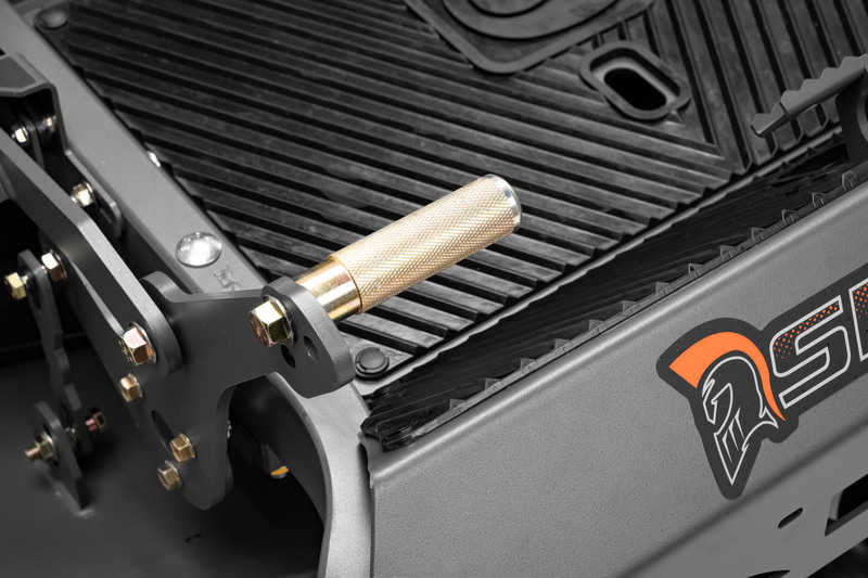 Close-up of a mechanical component with a gold-colored handle on a black and gray background.