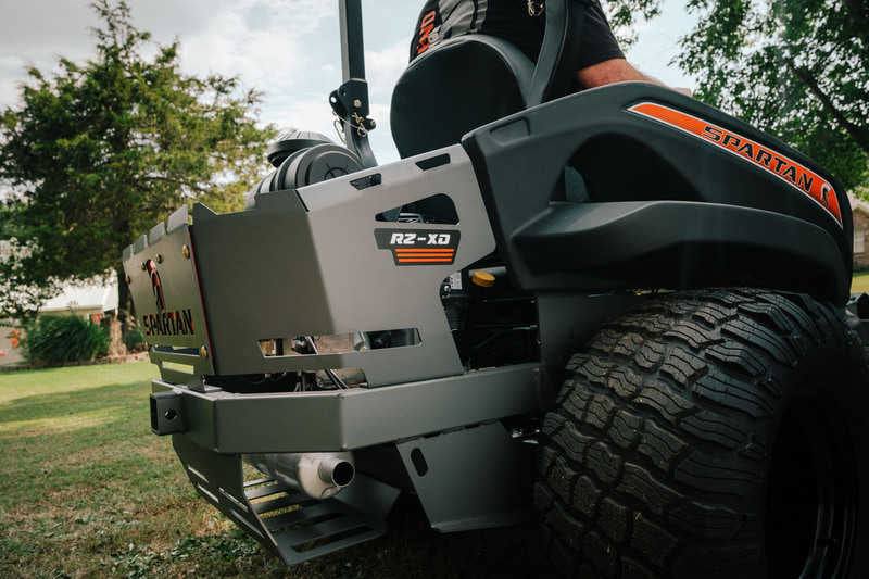 Close-up of a lawn mower with 'Spartan' branding on a grassy area.