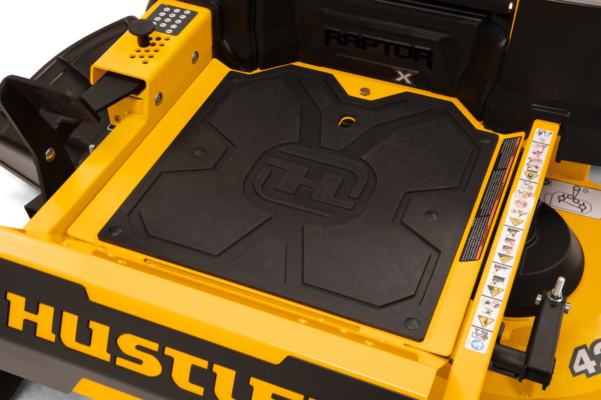 Close-up of a yellow Hustler lawn mower with 'Raptor' branding.