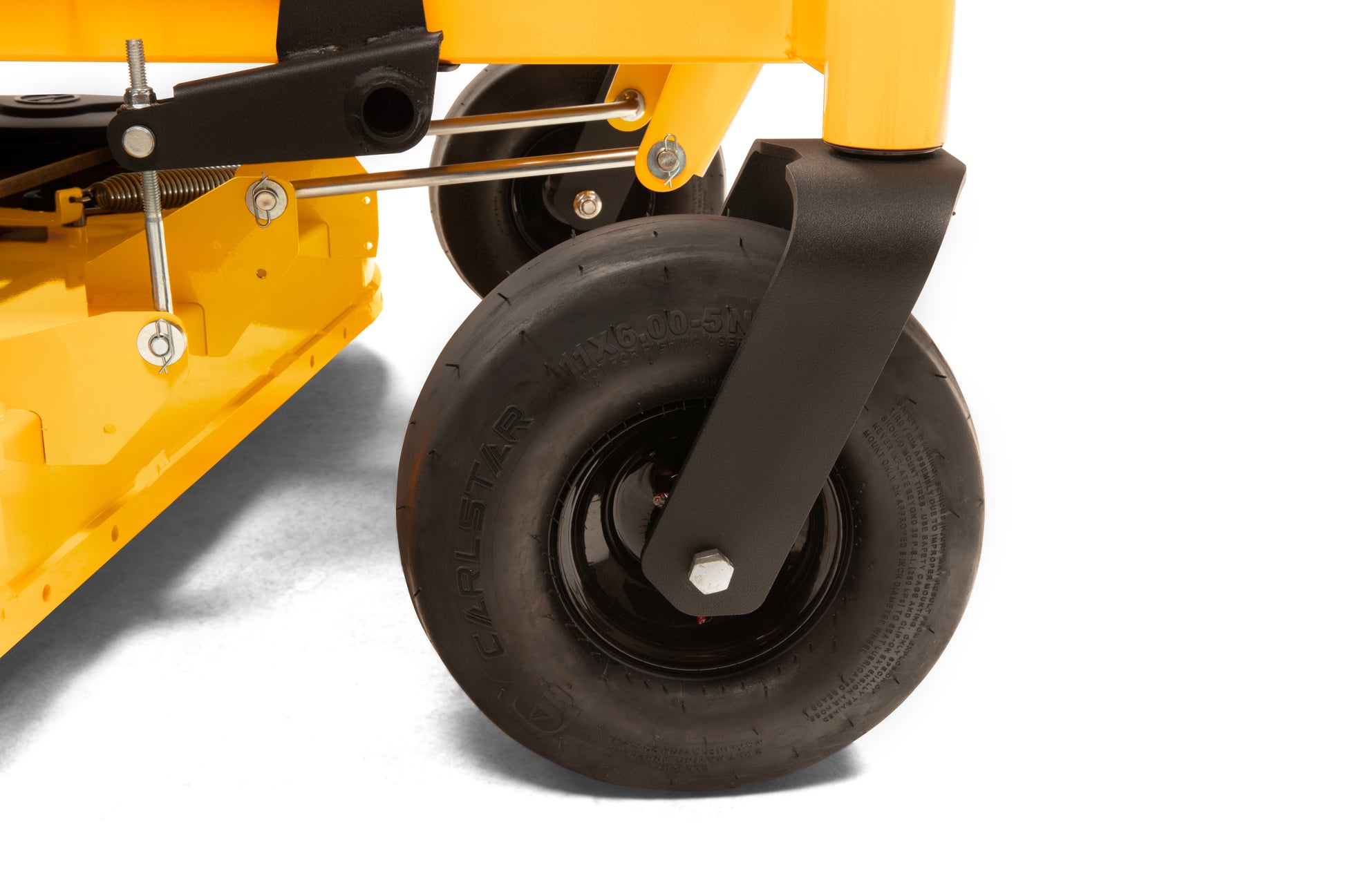 Close-up of a yellow lawn mower wheel on a white background
