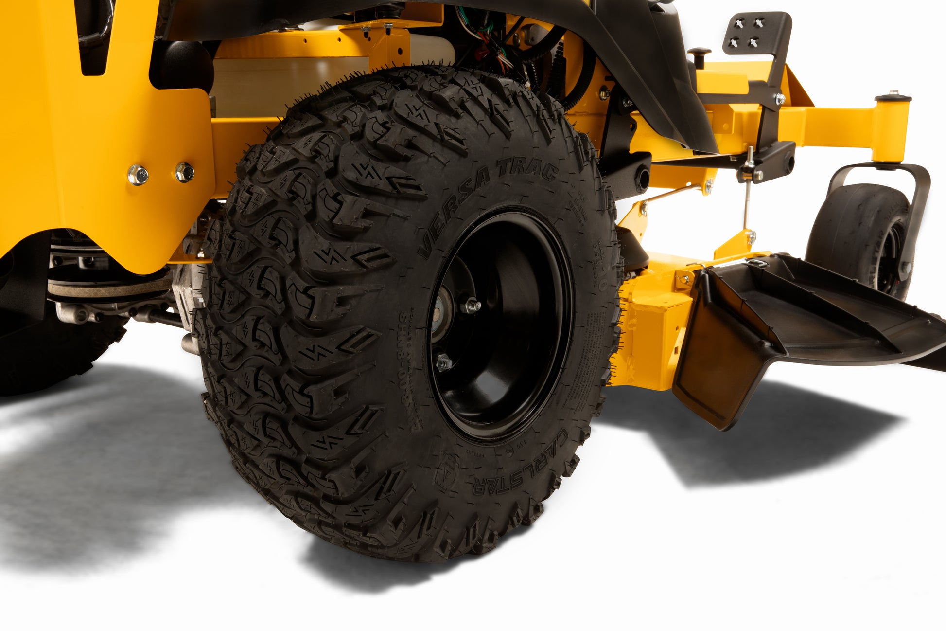 Close-up of a yellow lawn mower with a large black tire on a white background